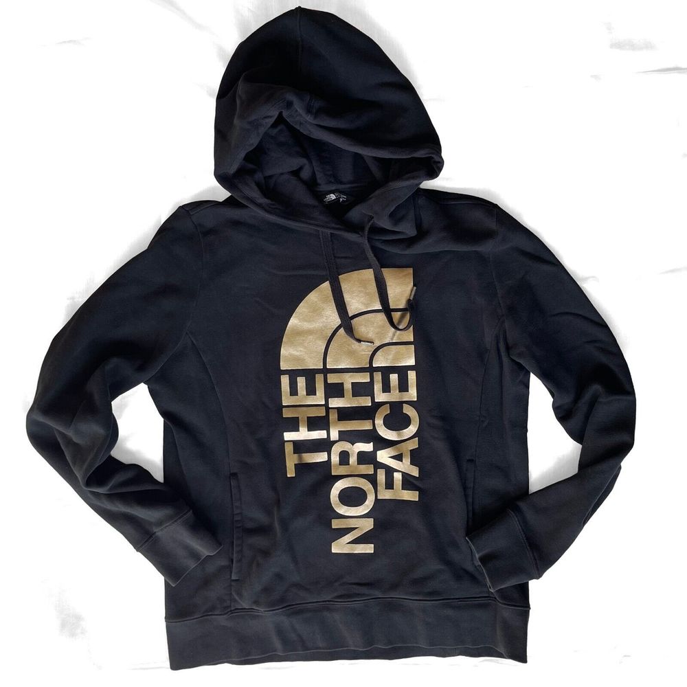 The North Face WMN's Gold Graphic Front Pocket Hoodie Pullover Sweater in Black
